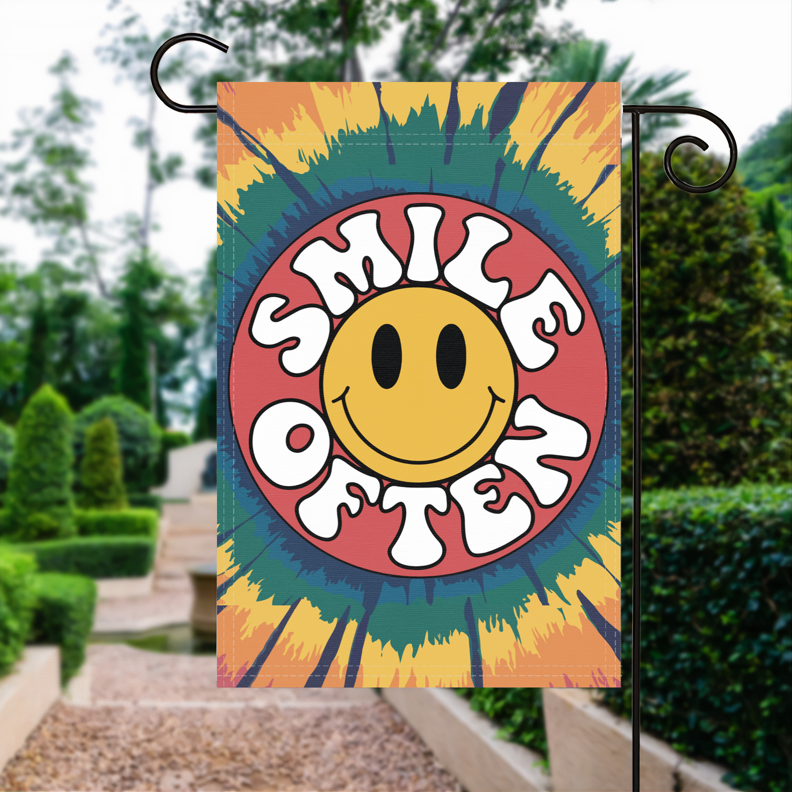 Smile Often Tie-Dye garden flag made of weatherproof polyester displayed in a garden | Bannerfi