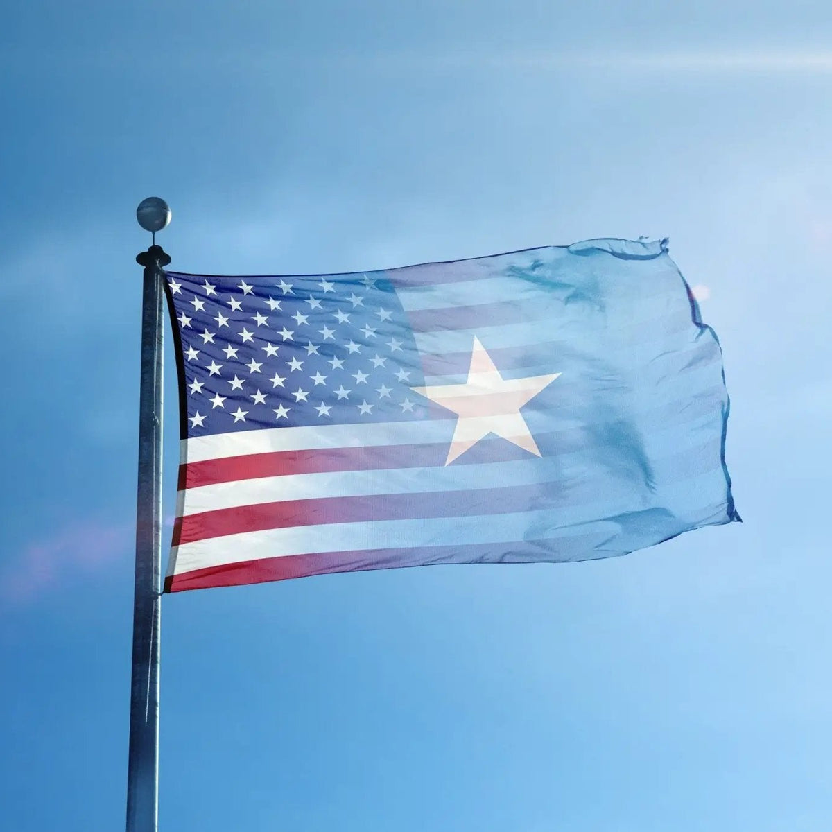 Somalian American Hybrid Flag; blue field with white stars, a large white star, and red-white stripes on a flagpole.