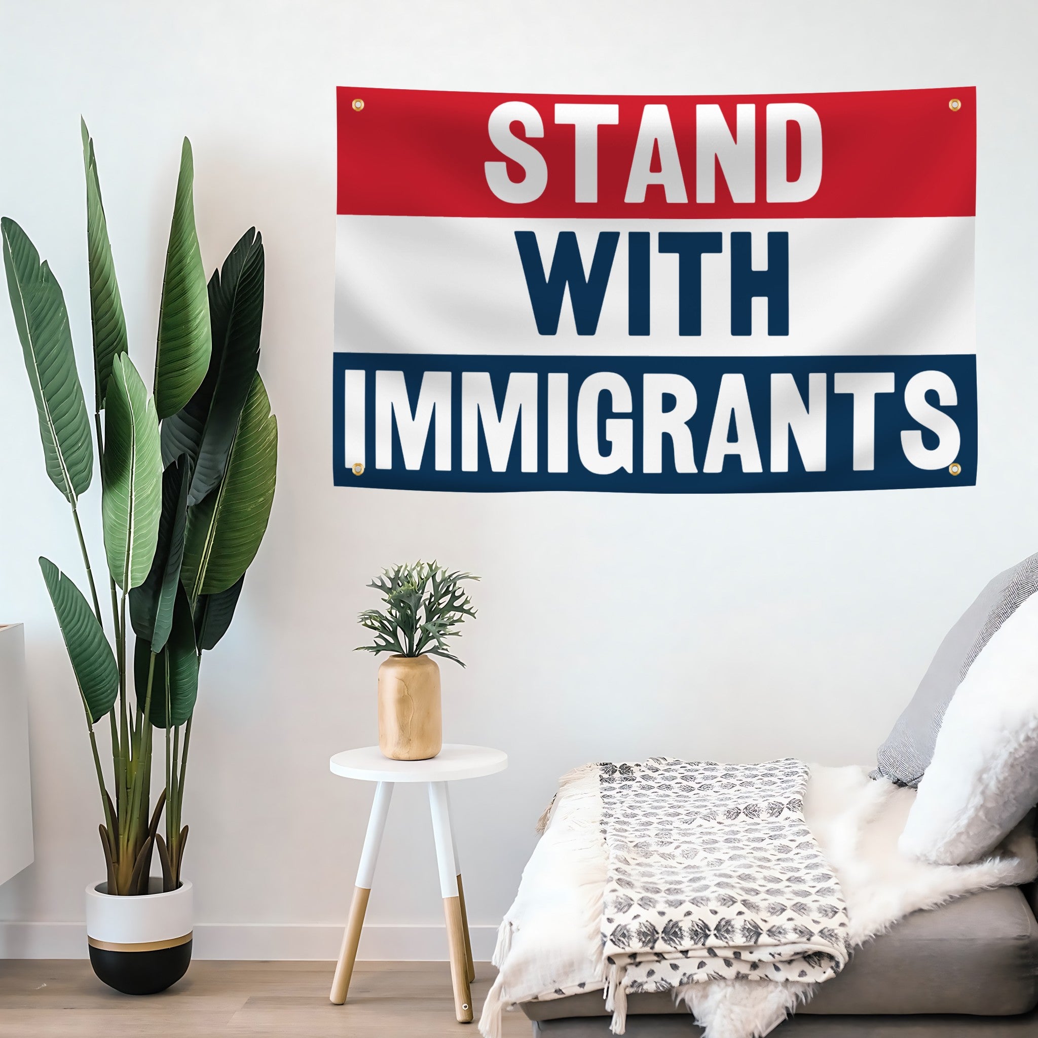 Banner reading 'Stand with Immigrants' in a room with plants and furniture.