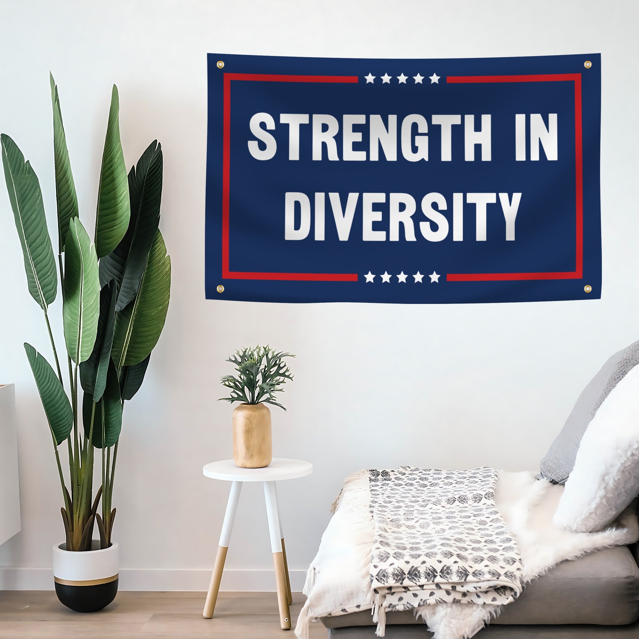 Living room with 'Strength in Diversity' banner on the wall, plants, and a sofa.