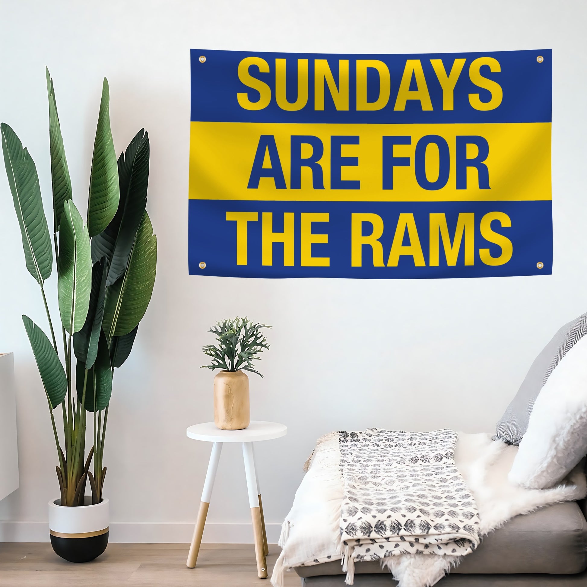 Decorative flag banner with 'Sundays are for the Rams' text in a room with plants and furniture.
