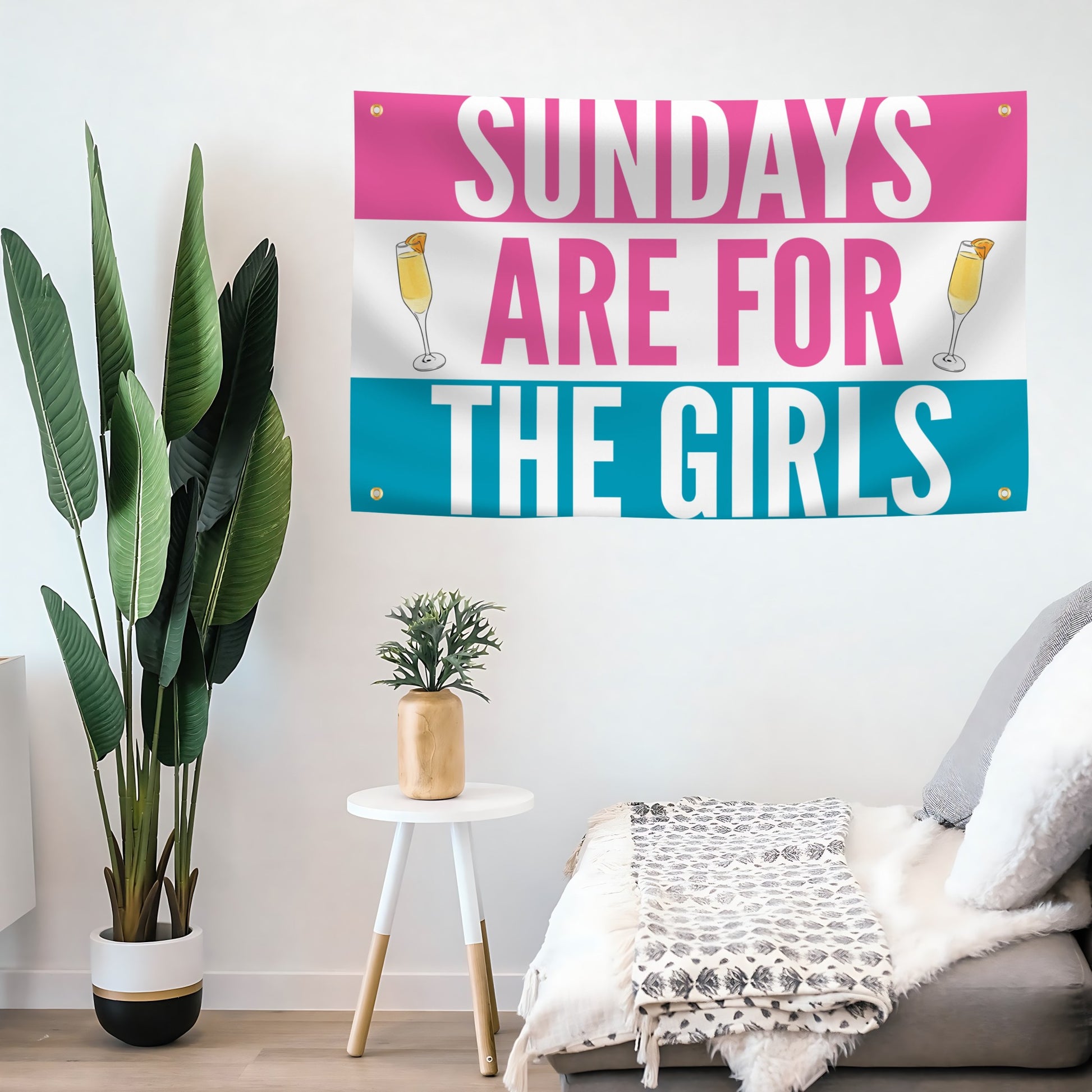 Decorative flag banner with 'Sundays are for the girls' text on a wall in a living room setting.