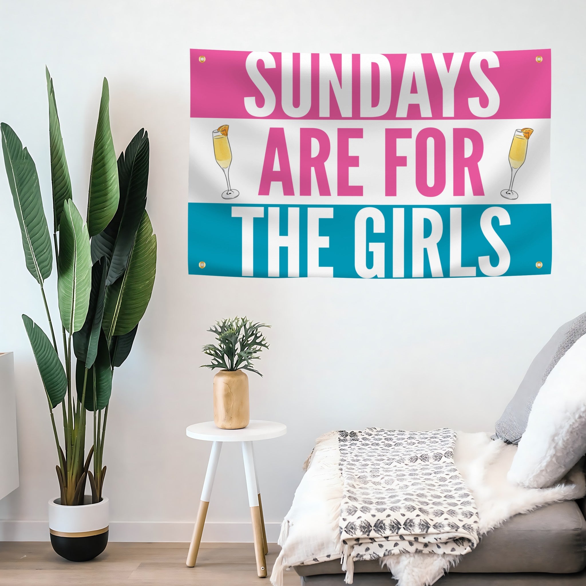 Decorative flag banner with 'Sundays are for the girls' text on a wall in a living room setting.