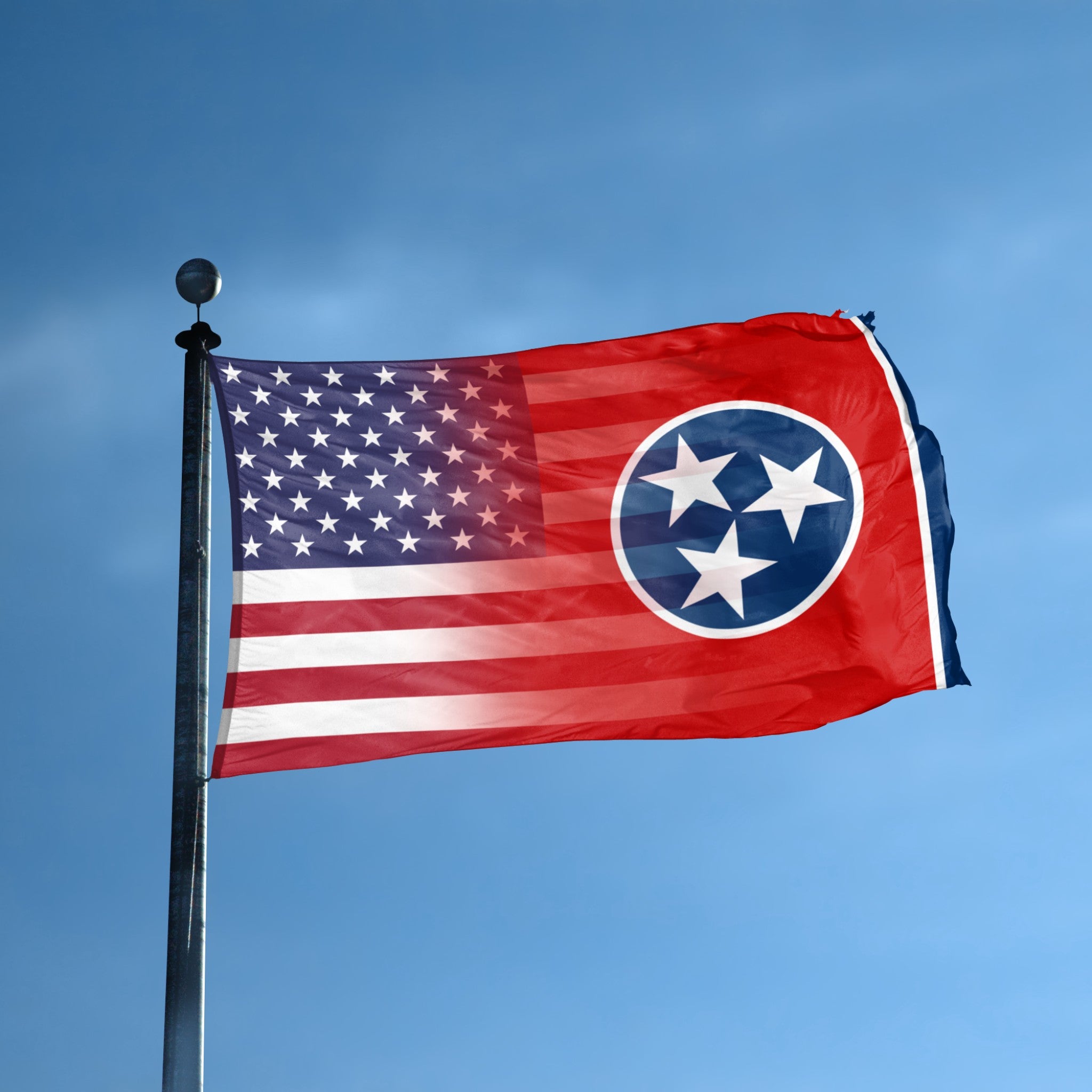 Flag of Tennessee blended with the American flag on a flagpole against a clear blue sky.
