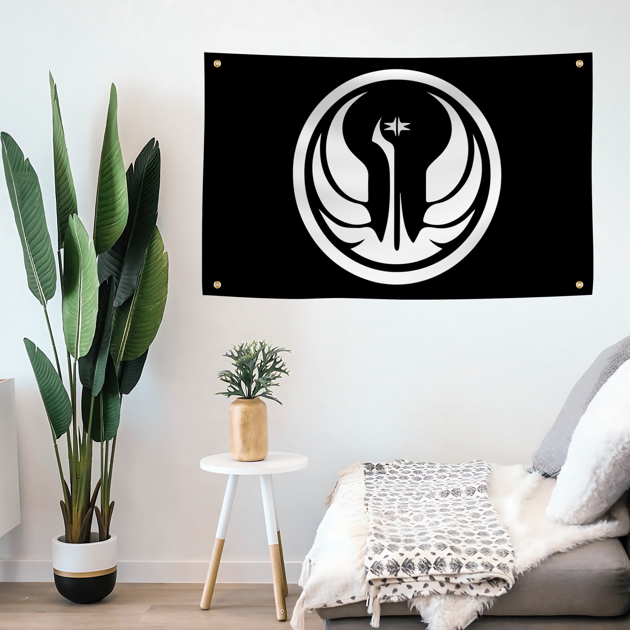 Black flag with white star wars old republic jedi emblem featuring a bird design, hanging on a wall above a sofa.