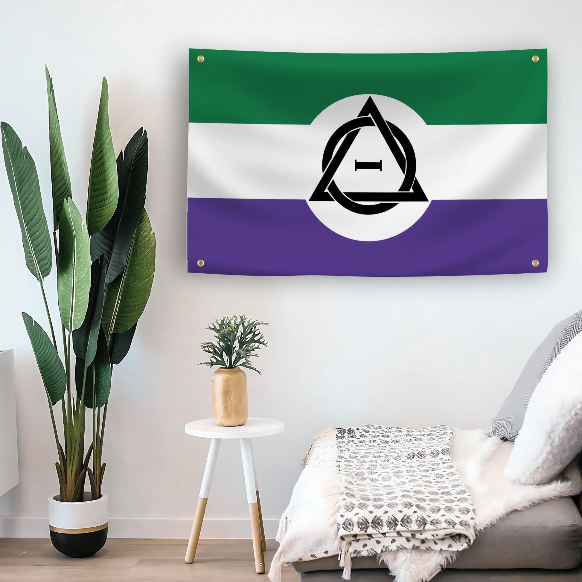 4 grommet unity flag with green, white, and purple horizontal stripes and a black therian symbol in the center symbolizing non-human identity on a wall.