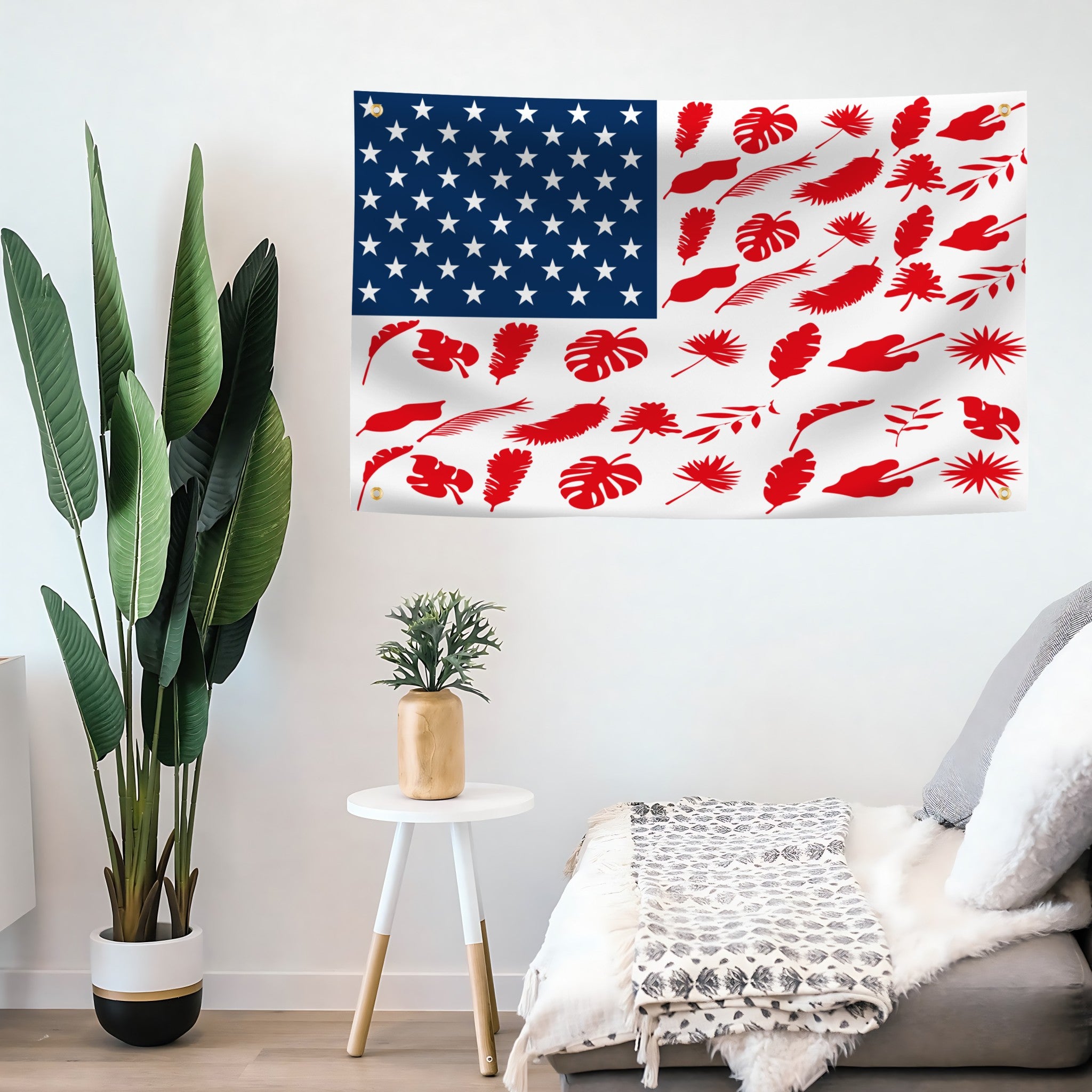 Living room with a sofa, plant, and wall art featuring an American flag and red leaf pattern.