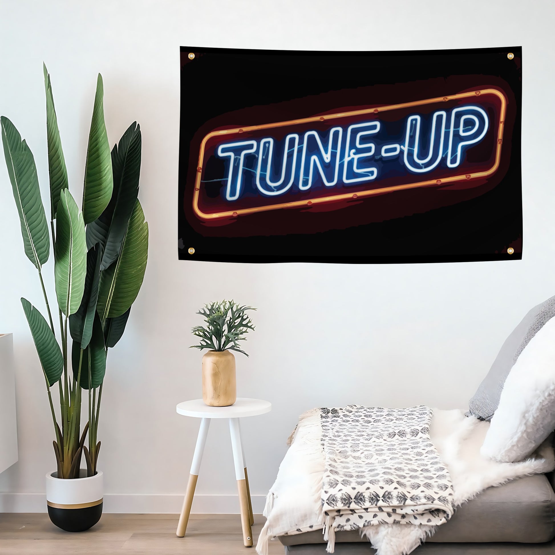 A flag banner with the words "Tune Up" mounted on a wall with grommets. 