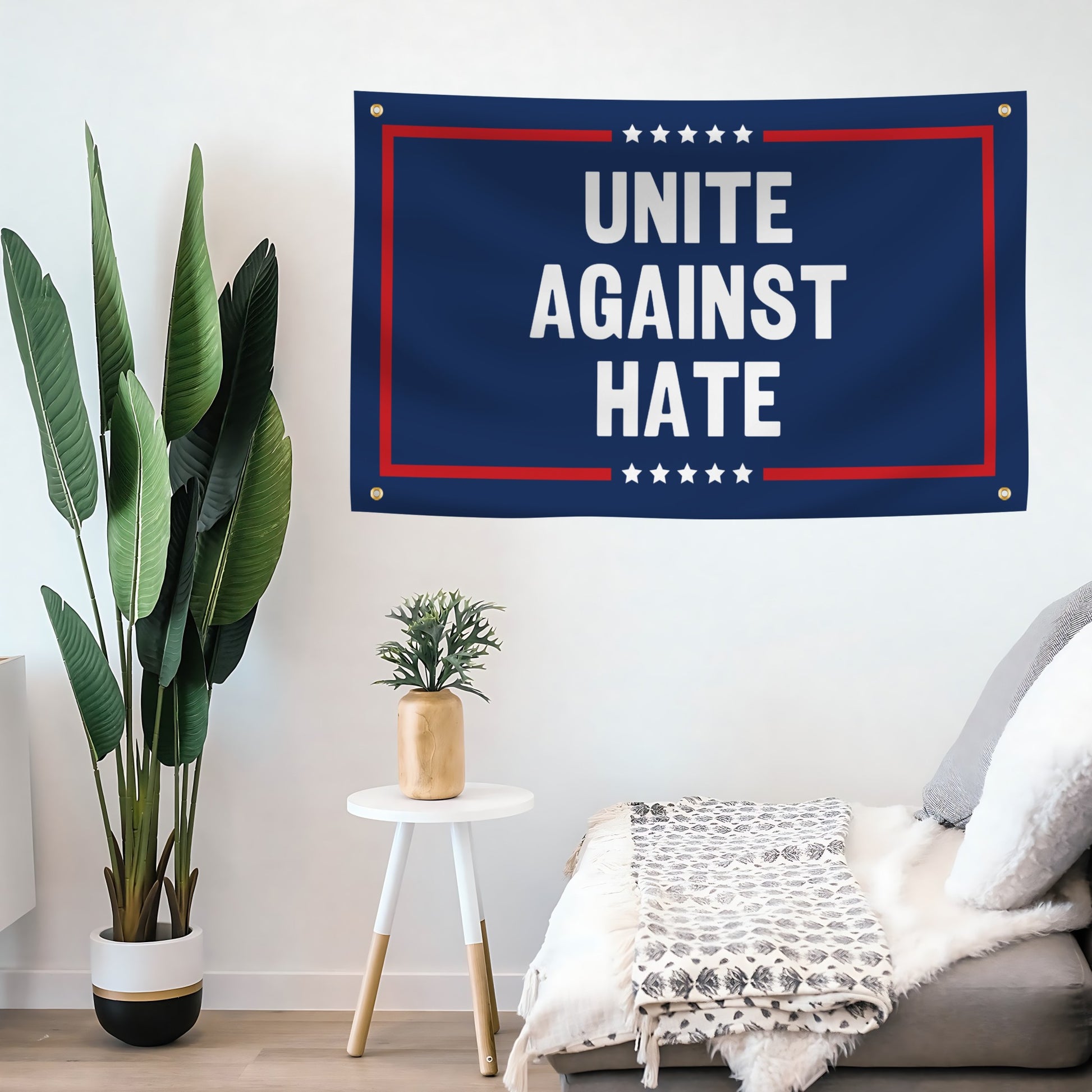 Flag banner with 'Unite Against Hate' text in a room with plants and furniture.