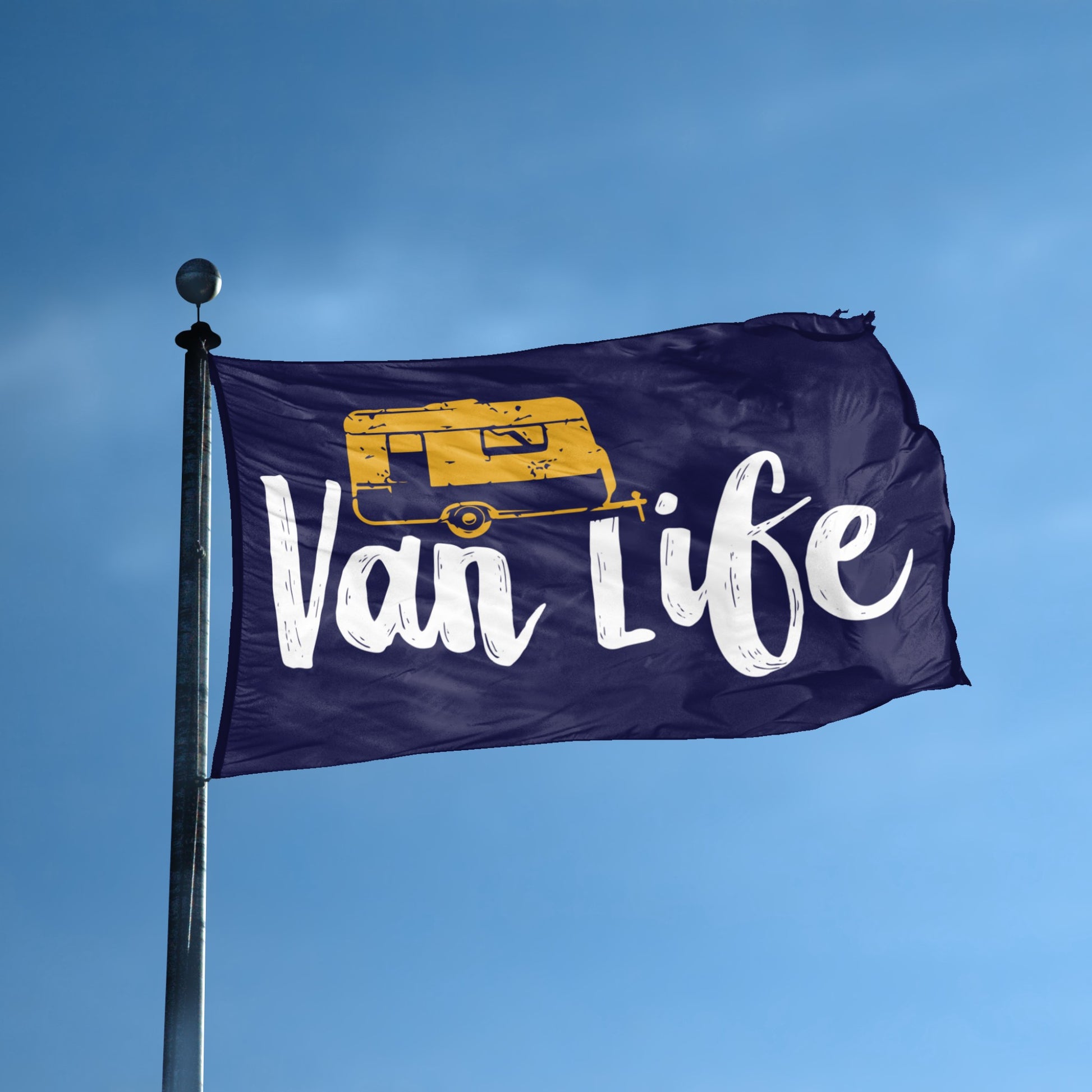 A flag with the theme "Van Life" displayed on a tall flag pole and blue skies.