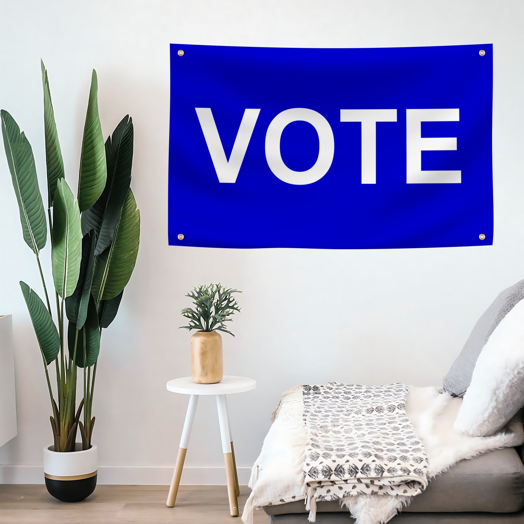 Blue 'VOTE' flag banner on a wall above a sofa with plants and a small table in the room.