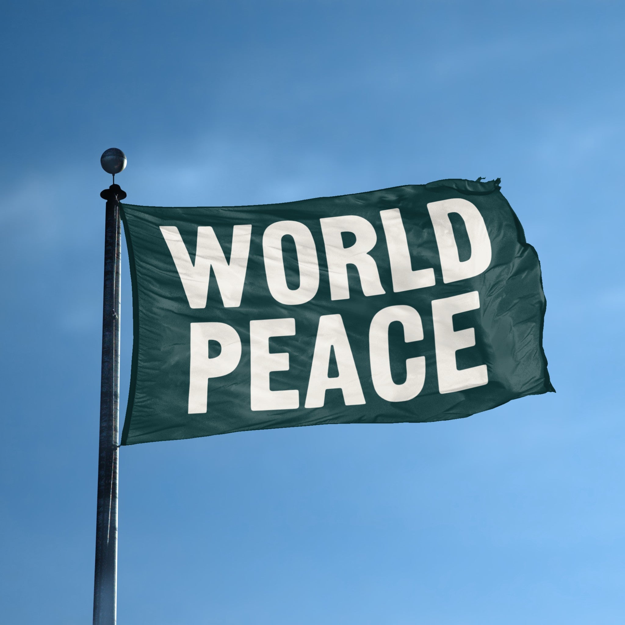 A flag with the theme "World Peace" displayed on a tall flag pole and blue skies.