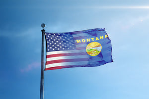 the flag of the state of montana flies high in the blue sky