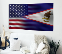 Load image into Gallery viewer, a living room with a couch, guitar, and american flag on the wall
