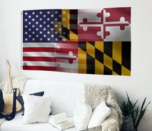 Load image into Gallery viewer, a living room with a white couch and a flag on the wall
