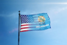 Load image into Gallery viewer, the flag of the state of oklahoma flies high in the blue sky
