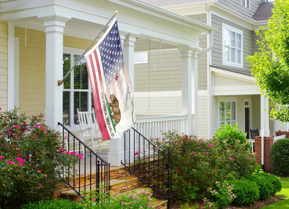 a flag on a porch next to a house