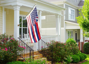an american flag on a flagpole in front of a house