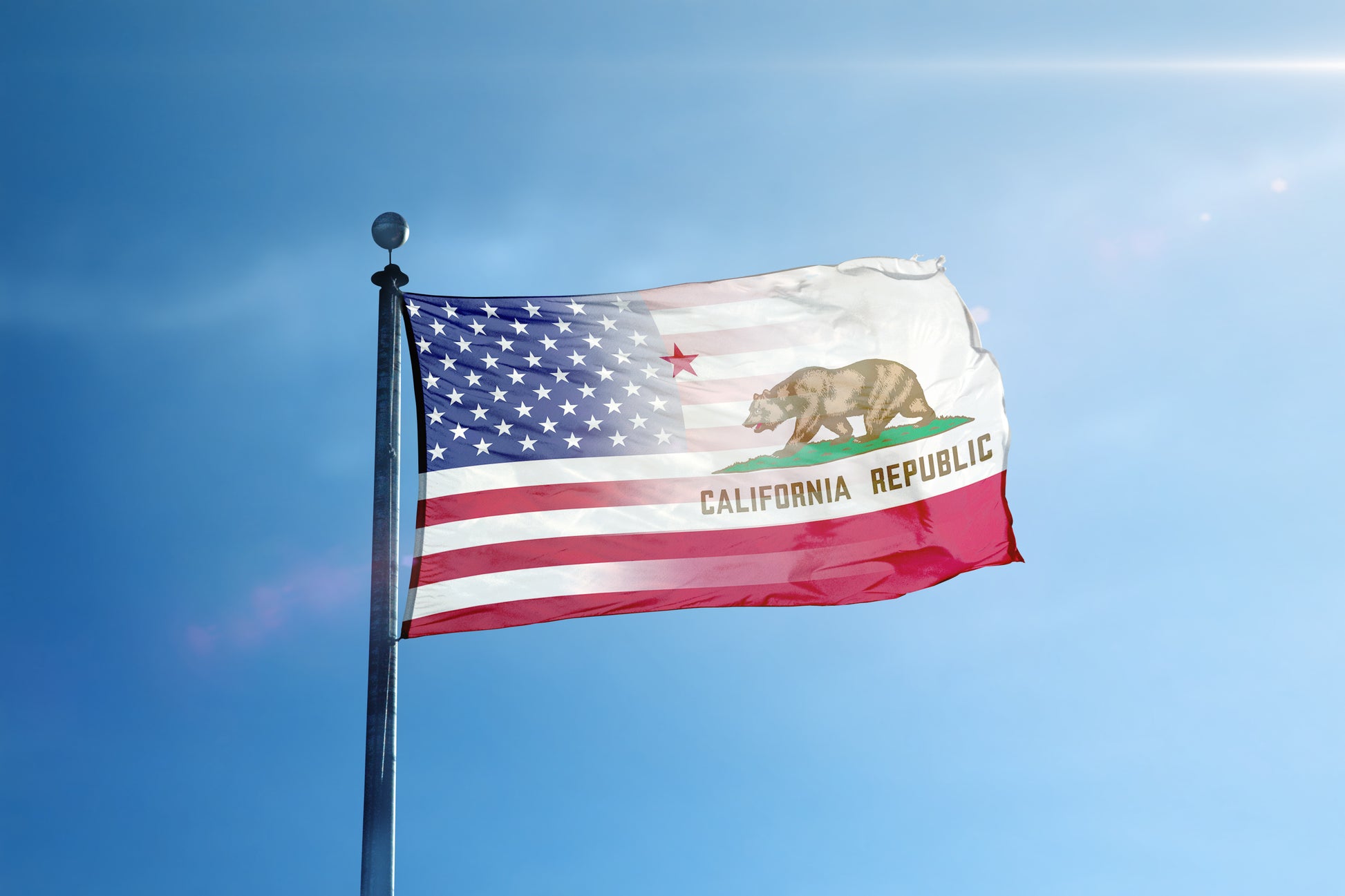 a flag flying in the wind with a blue sky in the background