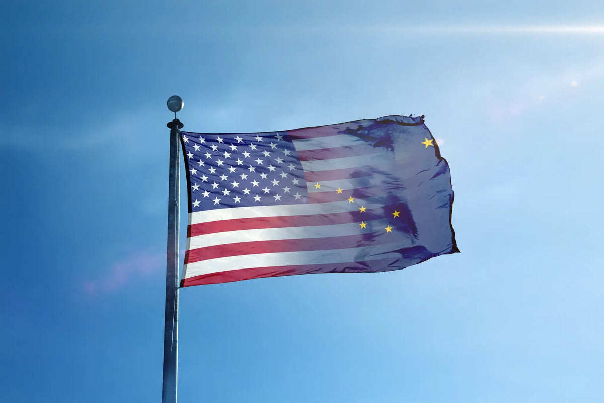Alaska & American Flag Blend house flag waving on a flagpole against a clear blue sky