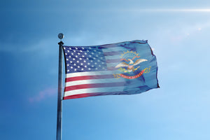 an american flag flying in the blue sky
