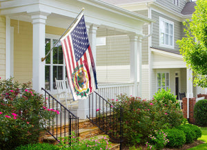 a flag on a porch next to a house