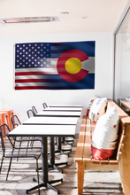 Load image into Gallery viewer, a room with a long table and a flag hanging on the wall
