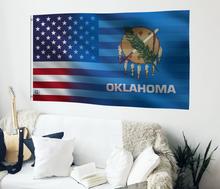 Load image into Gallery viewer, a flag hanging on a wall next to a couch
