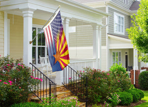 a flag on a porch next to a house