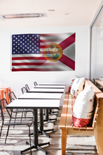 Load image into Gallery viewer, a room with a long table and a flag hanging on the wall
