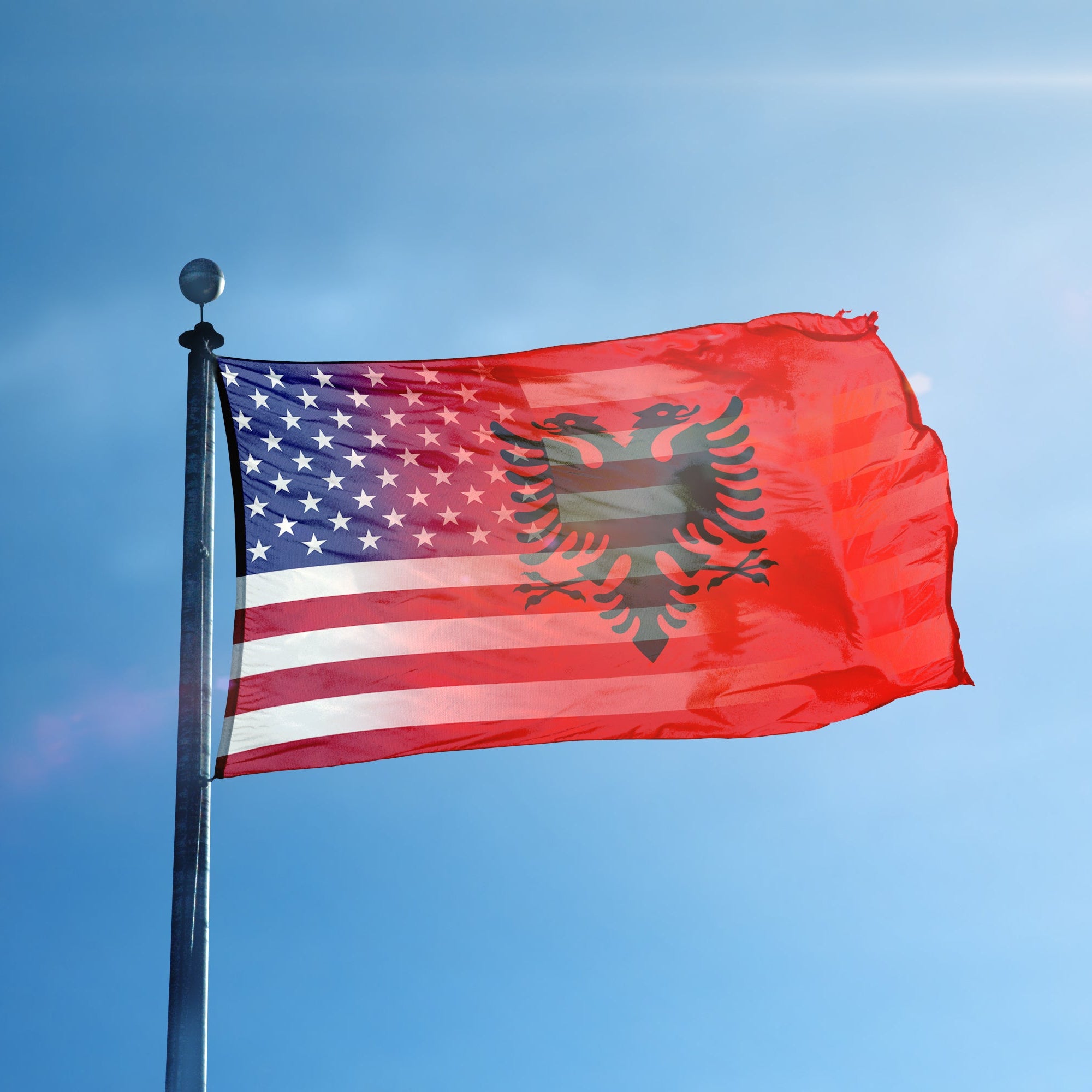 Flag with American and Albanian flag design blended together flying on a flagpole.
