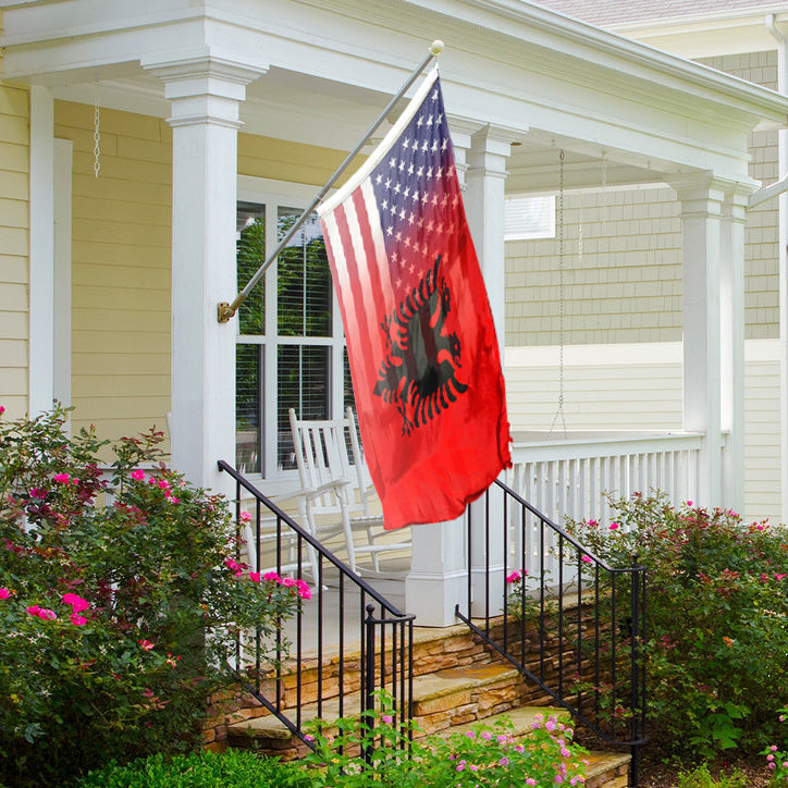 An American Albanian flag hybrid on a porch of a house.