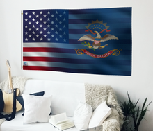 Load image into Gallery viewer, a living room with a couch and a flag on the wall
