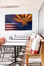 Load image into Gallery viewer, a room with a table, chairs, and a flag hanging on the wall
