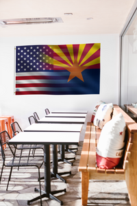 a room with a table, chairs, and a flag hanging on the wall
