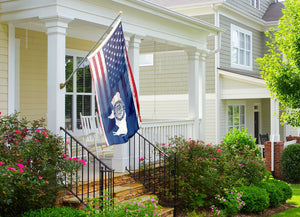 a flag on a porch next to a house