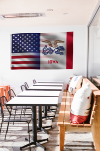 a long table with chairs and a flag hanging on the wall
