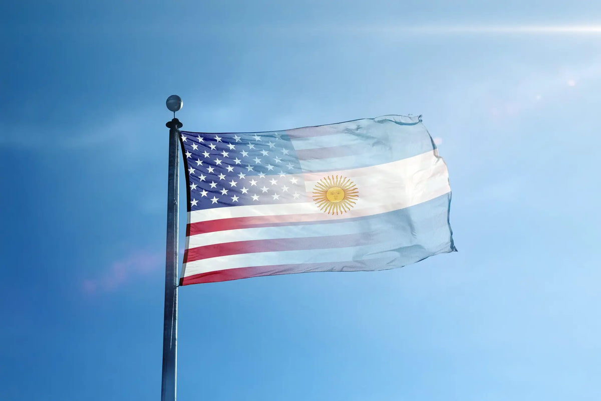 Argentinean American Hybrid Flag on flagpole; US stars and stripes blend with Argentine sun on a blue sky background.