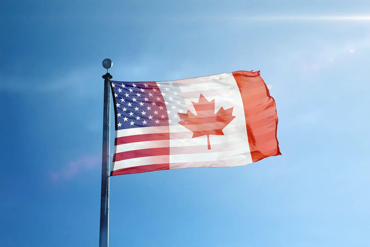 Canadian American Hybrid Flag house flag with US stars and Canadian maple design, fluttering on a flagpole.