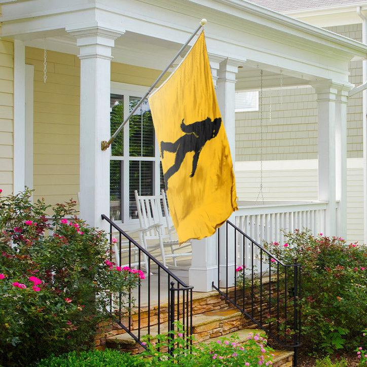 yellow Bigfoot Flag hanging on a front porch - Bannerfi