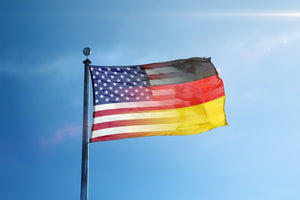 an american and german flag waving in the wind